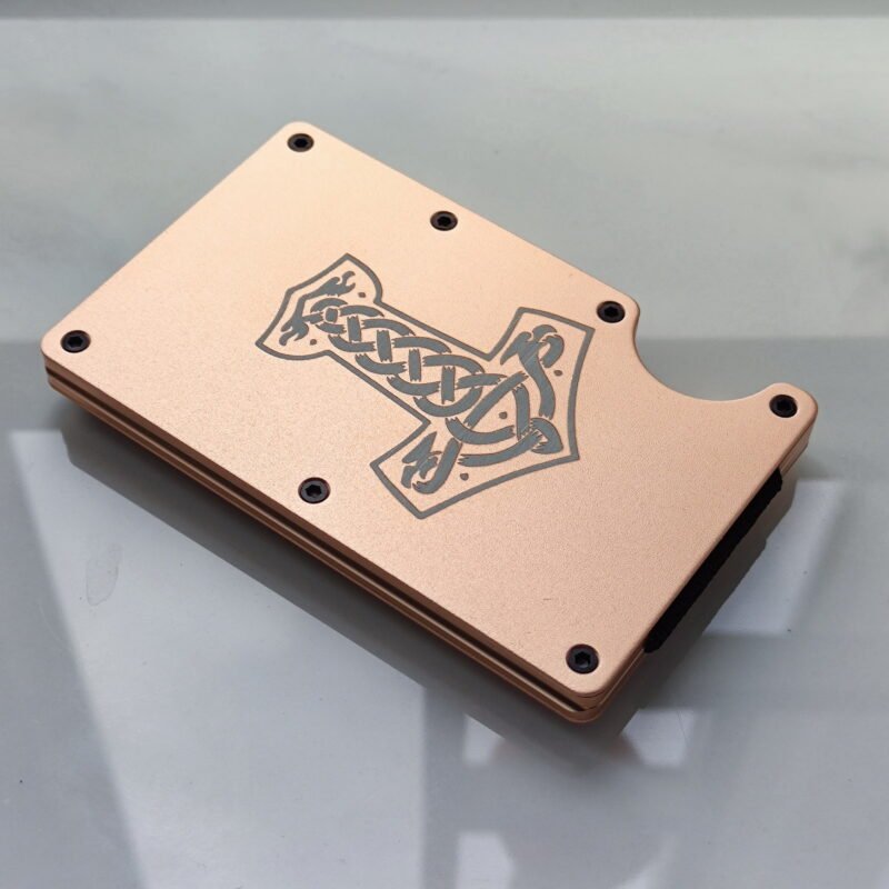 Metal RFID-blocking wallet featuring a deeply engraved Thor’s Hammer and Celtic knotwork, symbolizing protection and power.
